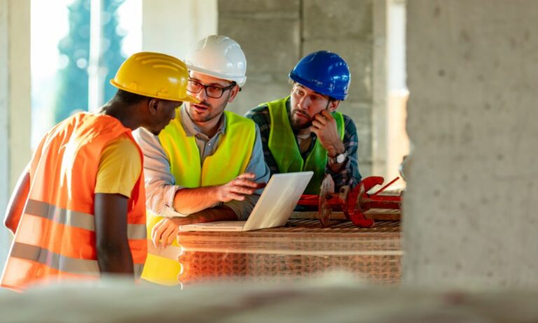 three construction project team members discussing Houston design build project